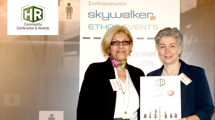 2 women representatives of Psimiti AE holding an award